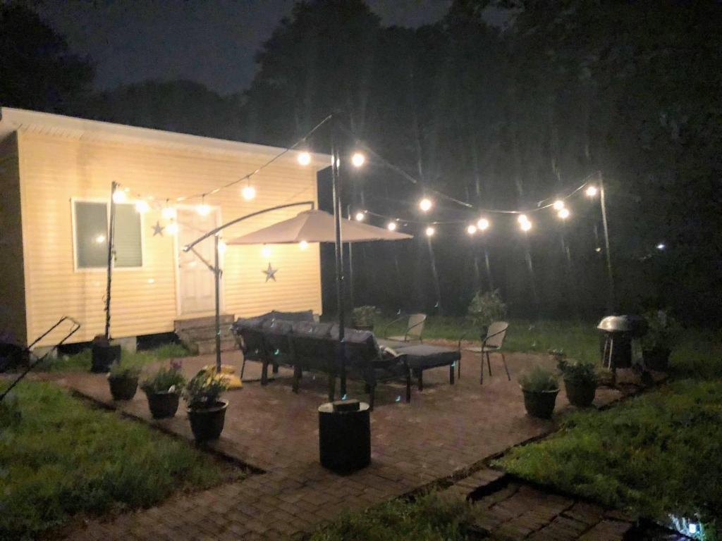 a patio with a table and lights at night at Cozy Mother-in-Law Suite in Norfolk