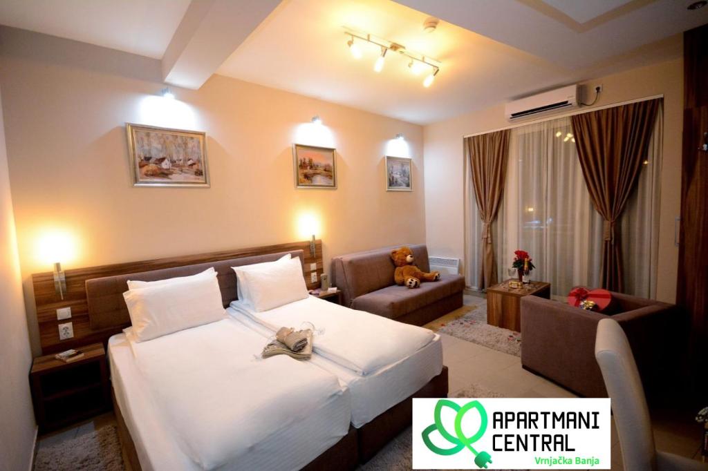 a hotel room with a bed and a chair at Apartmani Central 2.0 & Free parking in Vrnjačka Banja