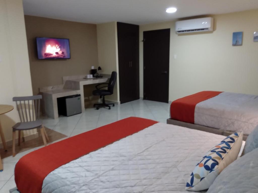 Postel nebo postele na pokoji v ubytování EXECUTIROOMS VERACRUZ