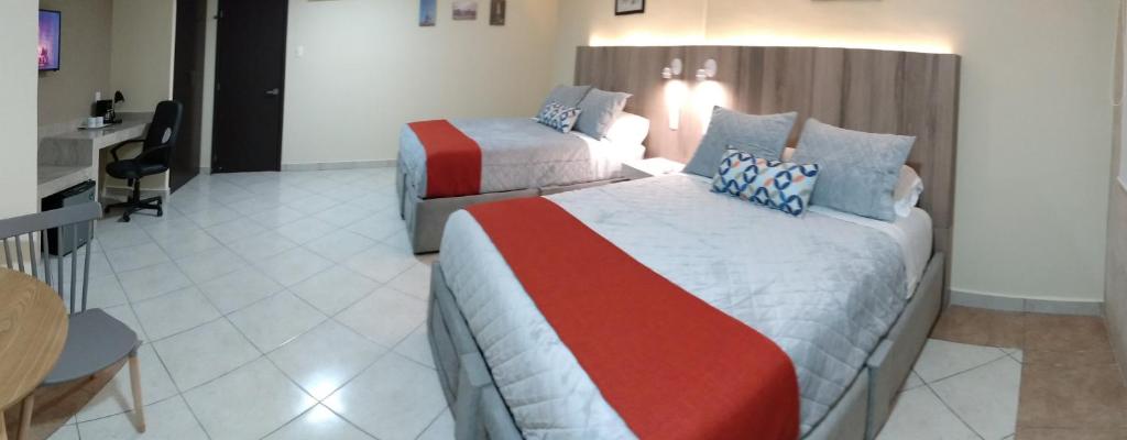 Postel nebo postele na pokoji v ubytování EXECUTIROOMS VERACRUZ
