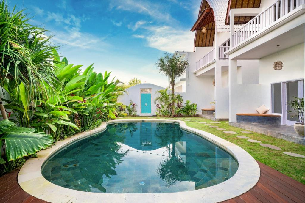 a swimming pool in the backyard of a house at Kelana Uluwatu in Uluwatu
