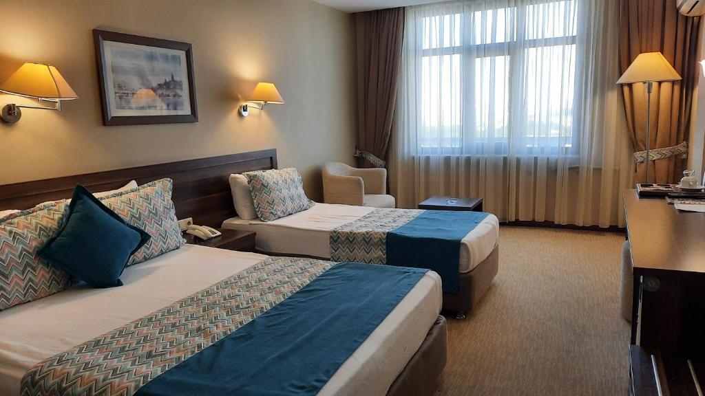 Postel nebo postele na pokoji v ubytování Plaza Hotel Diyarbakir
