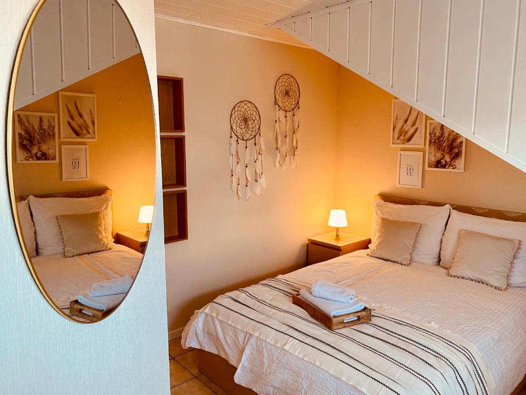 a bedroom with a bed and a mirror at Ferienwohnung Bornheim in Bornheim