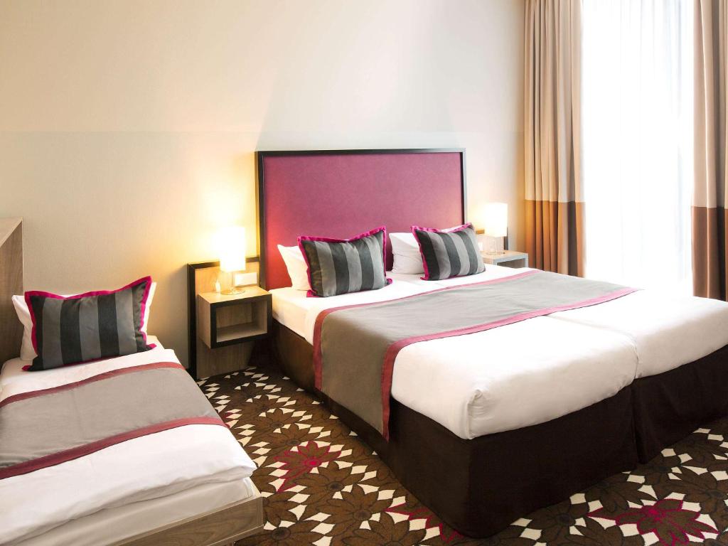 Кровать или кровати в номере Mercure Hotel MOA Berlin