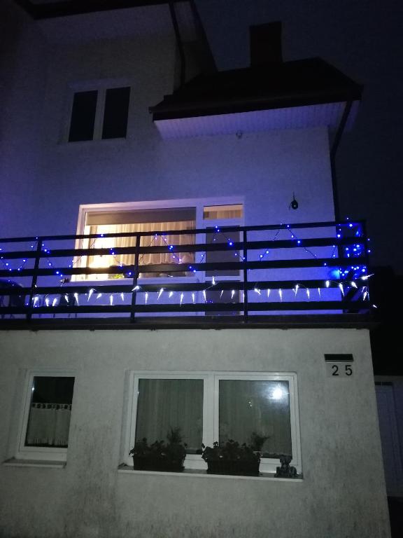 un balcón con luces azules en el lateral de un edificio en Apartament szafirowa25 pietro1, en Kołobrzeg