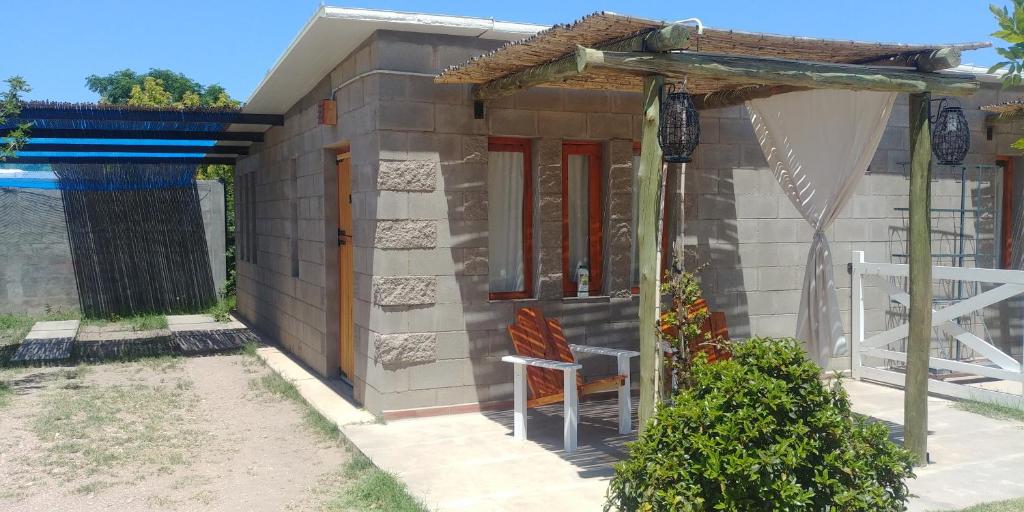 una pequeña casa con una silla delante en Nelumbo Petit Chalet en San Rafael