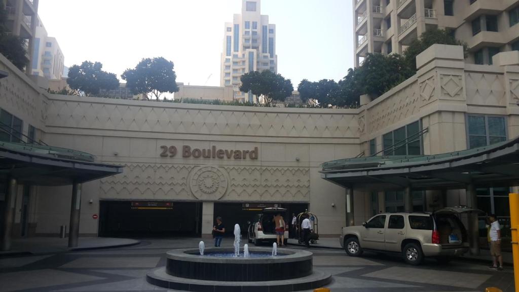 a white truck parked in front of a building at TOWER 2 DOWNTOWN APARTMENT 29 BOULEVARD in Dubai