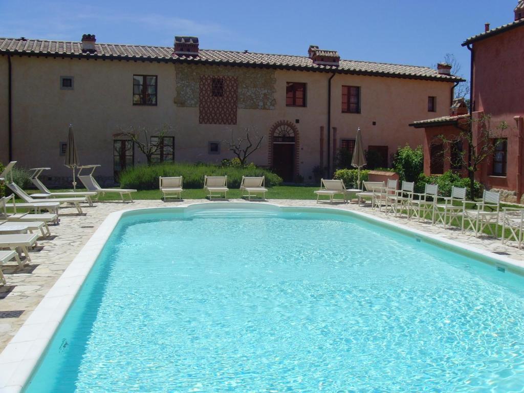 a swimming pool in front of a house at Toscana Relax Gambassi Terme in Gambassi Terme