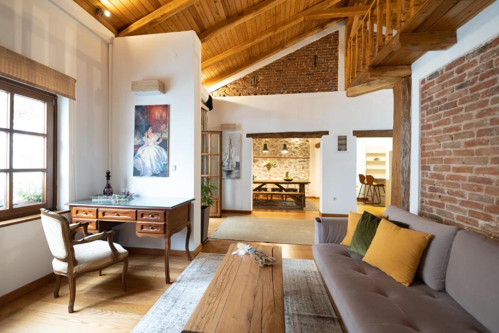 a living room with a couch and a table at Four Season Maison in Kavála