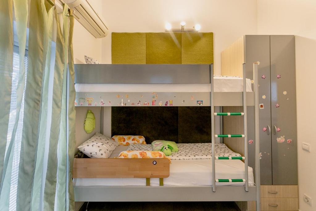 Postel nebo postele na pokoji v ubytování Olive Garden Apartment