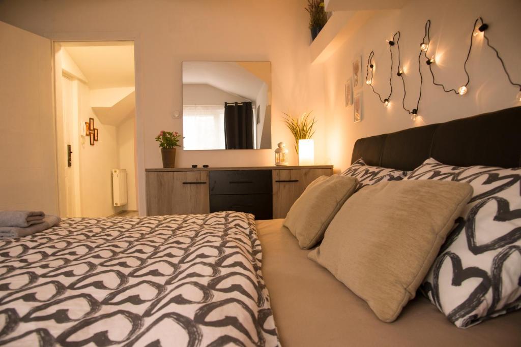 a bedroom with a large bed and a mirror at Central Sweet Home I.M. in Novi Sad