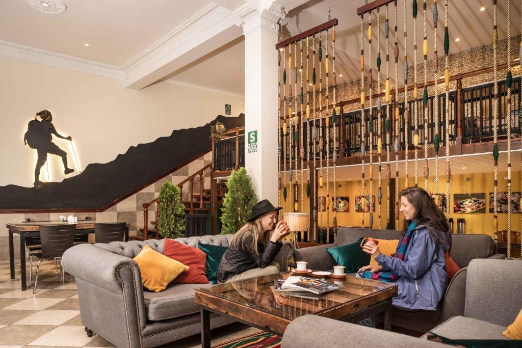 two women sitting in the lobby of a hotel at Maytaq Wasin Boutique Hotel in Cusco