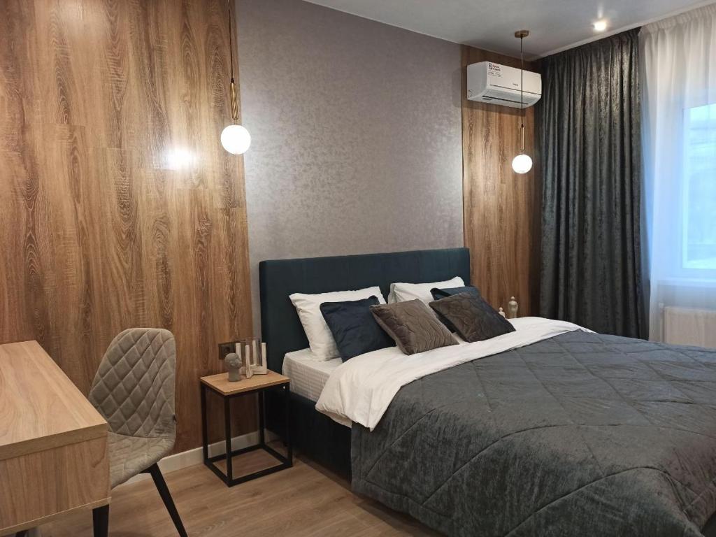 a bedroom with a bed and a desk and a chair at Citylife Boutique Hotel in Kharkiv
