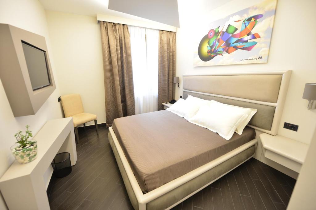 Uma cama ou camas num quarto em Petit Hotel Elita