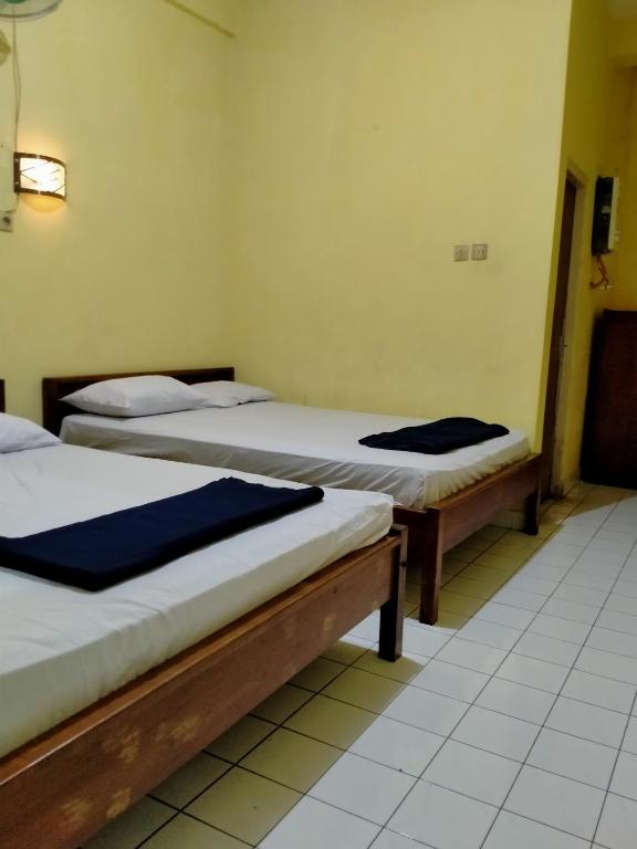 Postel nebo postele na pokoji v ubytování Prayogo Lama Family GH Prawirotaman