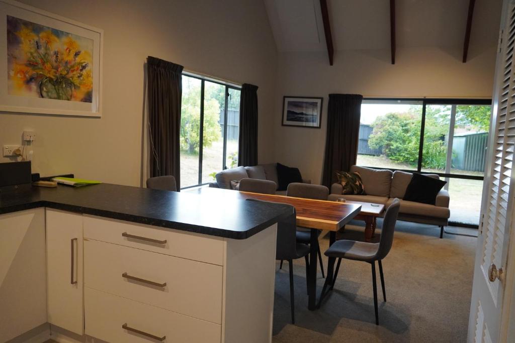 a kitchen and living room with a table and chairs at Lazy Daze in Wanaka