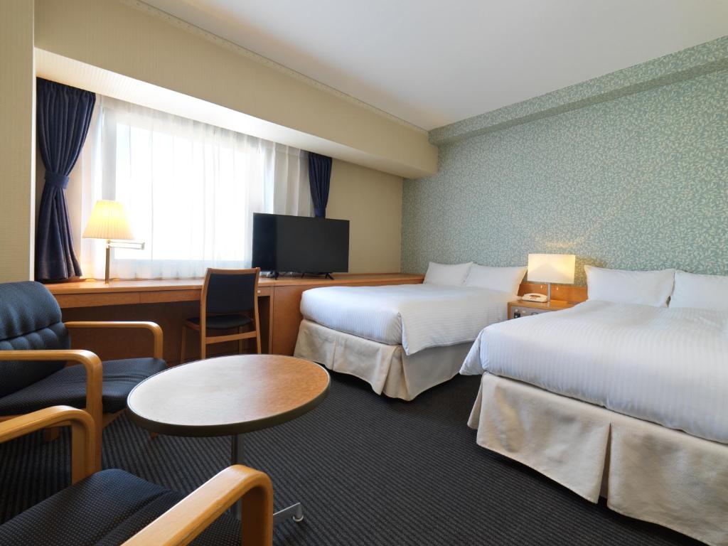 Postel nebo postele na pokoji v ubytování Hotel Emisia Tokyo Tachikawa