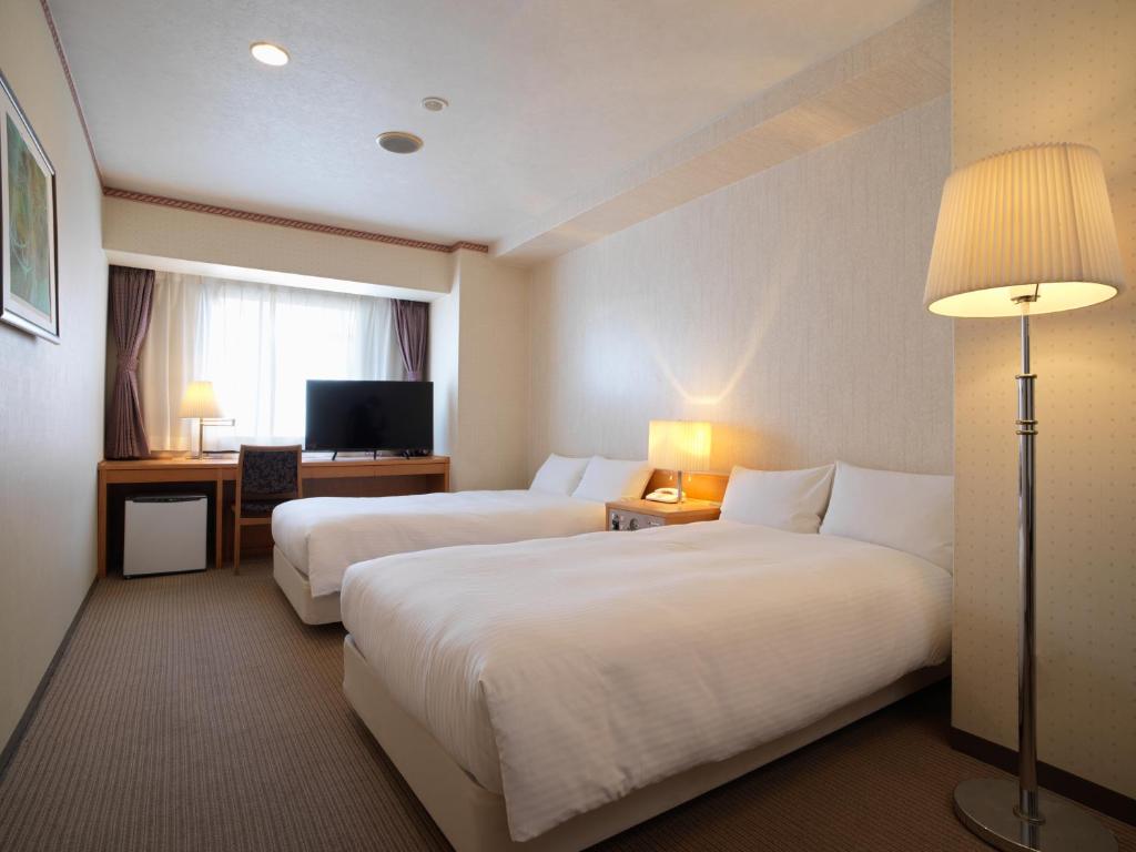 Postel nebo postele na pokoji v ubytování Hotel Emisia Tokyo Tachikawa