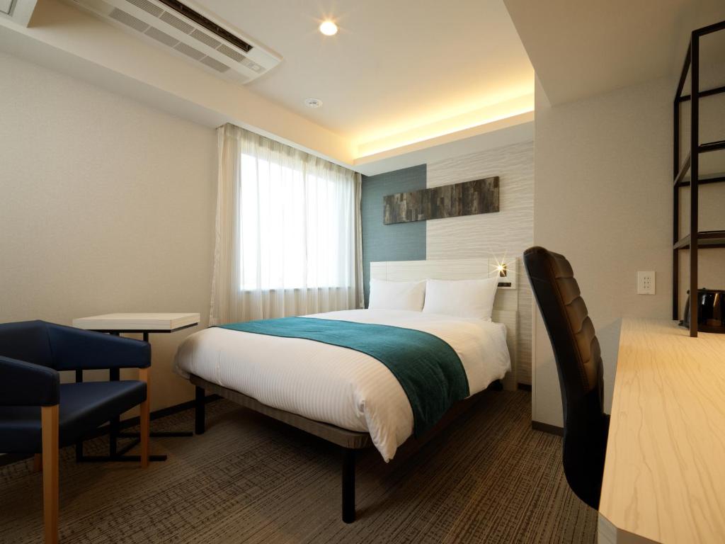 Postel nebo postele na pokoji v ubytování Hotel Emisia Tokyo Tachikawa