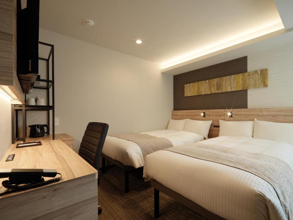Postel nebo postele na pokoji v ubytování Hotel Emisia Tokyo Tachikawa