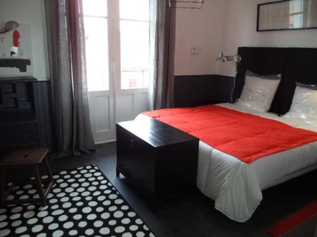 a bedroom with a large bed with a red blanket at Toki Alai in Saint-Jean-de-Luz