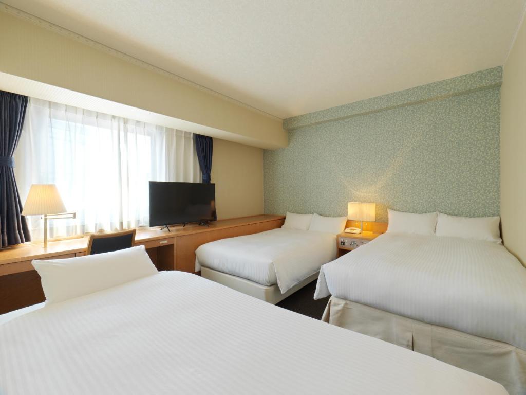 Postel nebo postele na pokoji v ubytování Hotel Emisia Tokyo Tachikawa
