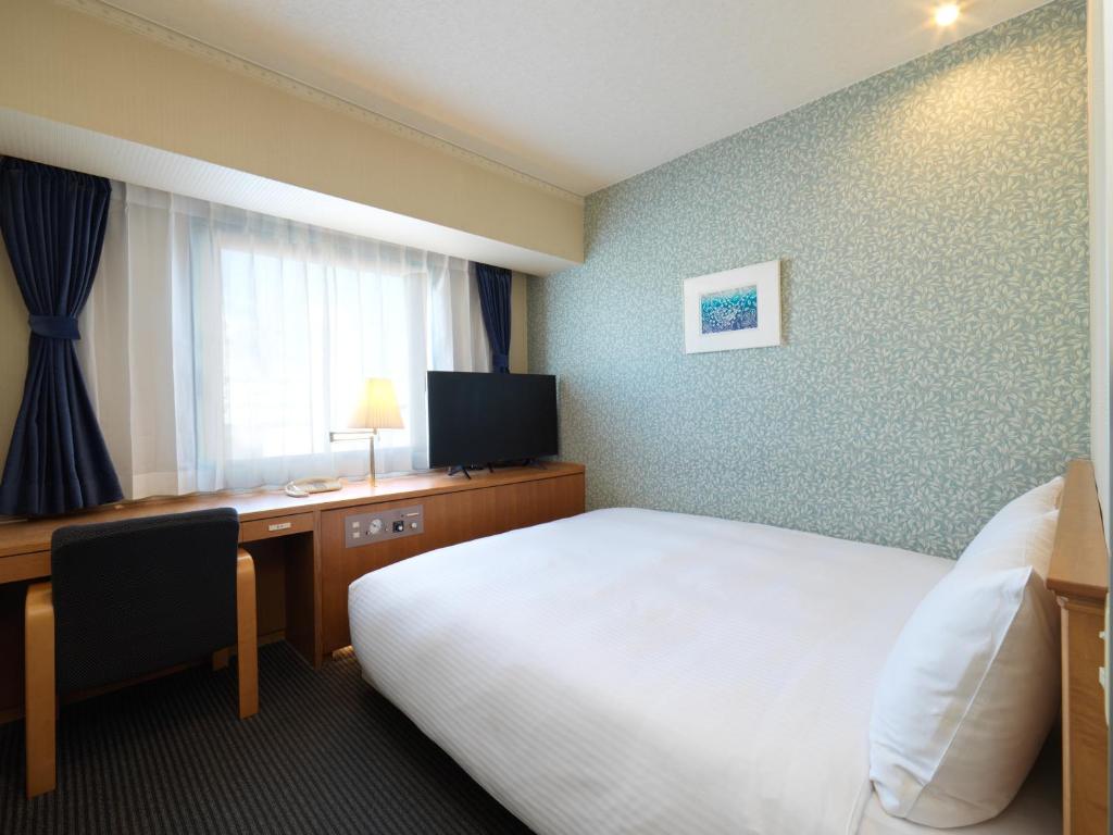 Postel nebo postele na pokoji v ubytování Hotel Emisia Tokyo Tachikawa