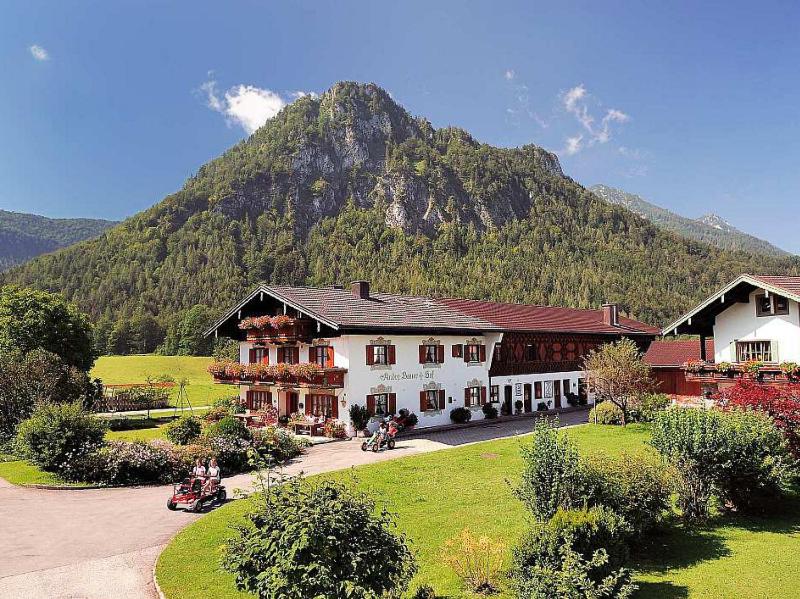 a large building with a mountain in the background at Andrebauernhof - Biohof - Chiemgau Karte in Inzell