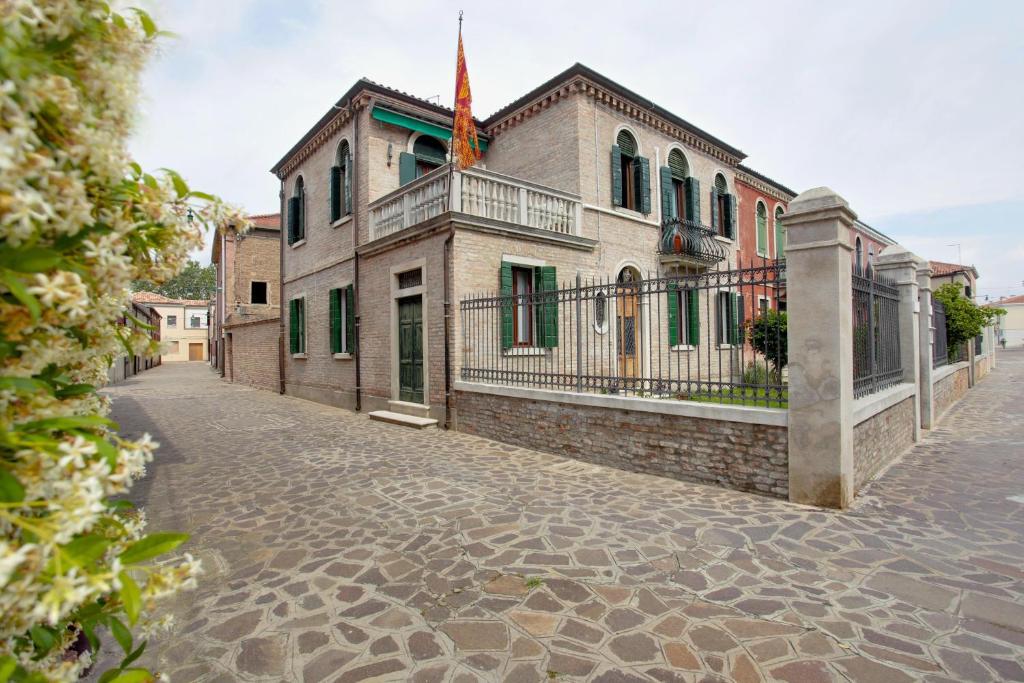 um edifício antigo com uma varanda numa rua de calçada em Ca' Bernardo em Murano