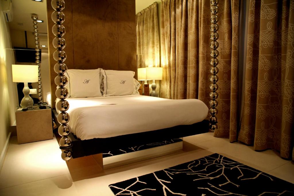 a bedroom with a bed with a large swing at Abalú Small Luxury & Design Boutique Hotel in Madrid