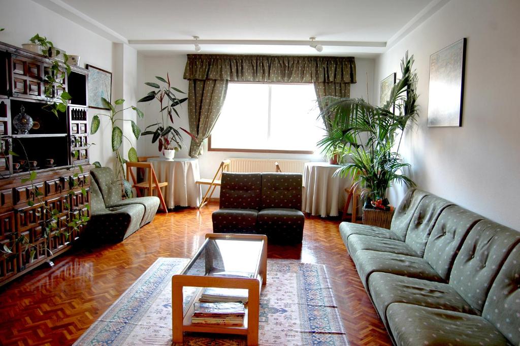 uma sala de estar com um sofá e uma mesa em Hostal Charo II em Santiago de Compostela