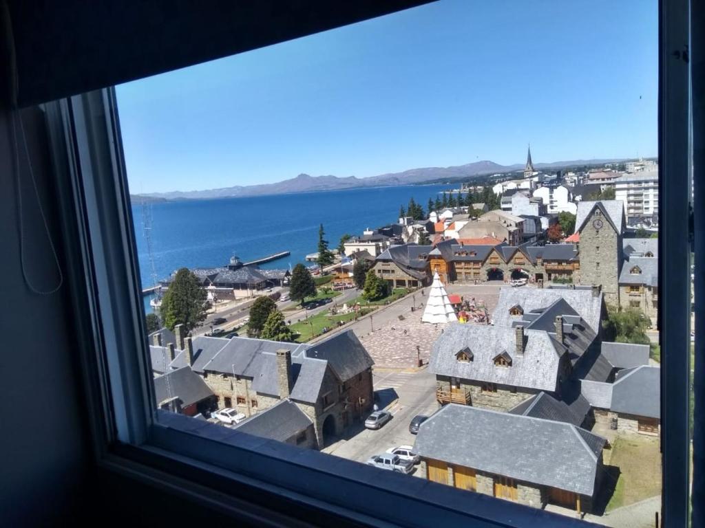 a view of a town from a window at Apartamento Bariloche Center in San Carlos de Bariloche