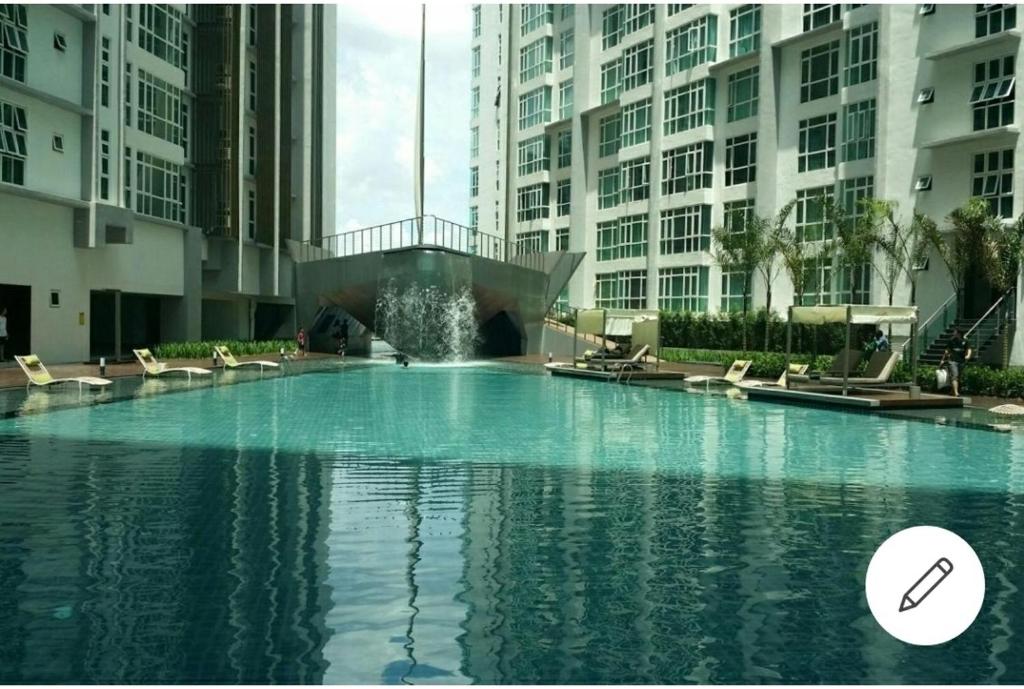 a large pool of water in front of some buildings at Central residence in Kuala Lumpur