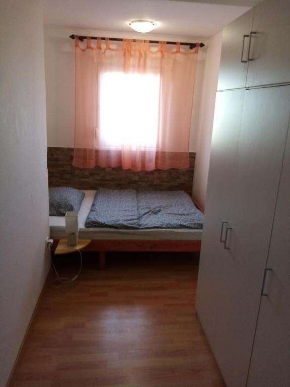 a small room with a bed and a window at Apartment Buic in Pula