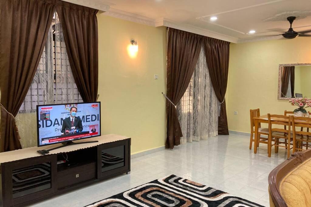 a living room with a flat screen tv on a table at Hanna Homestay Kangar in Kangar