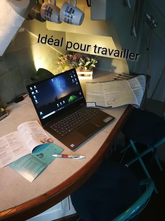 a laptop computer sitting on top of a desk at Study du pêcheur in Trouville-sur-Mer