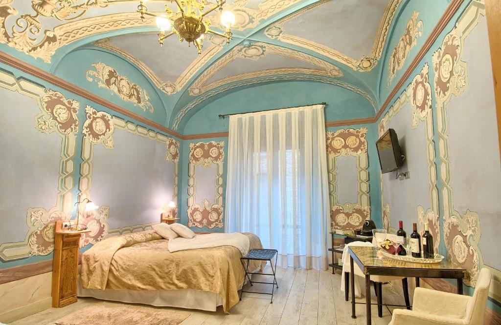 a bedroom with a large bed with a ceiling at Hotel-Spa Classic Begur in Begur