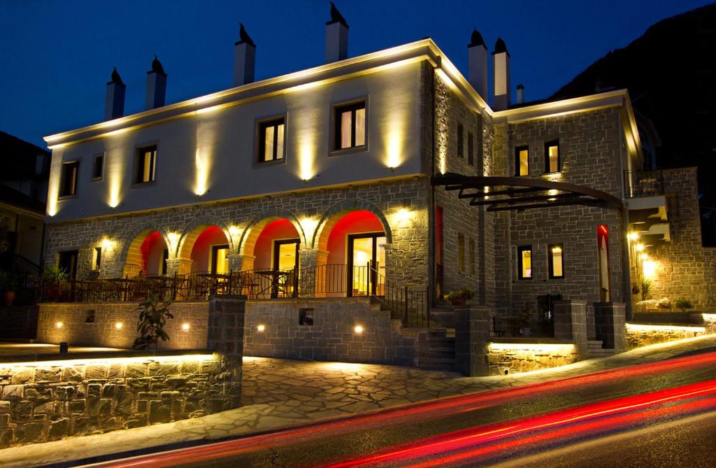 a building with lights on it at night at Hotel Rodovoli in Konitsa
