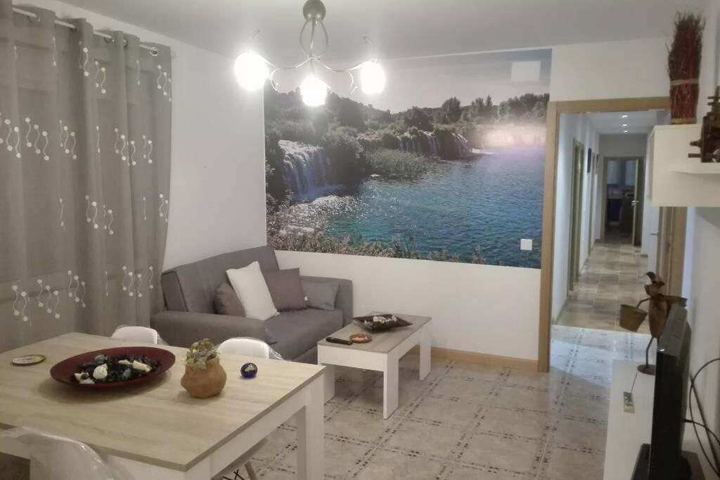 a living room with a couch and a table at VIVIENDA VACACIONAL EL MOLINO ARGAMASILLA DE ALBA in Argamasilla de Alba