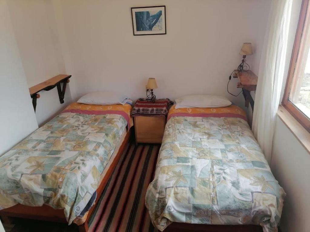 Postel nebo postele na pokoji v ubytování Hostal Inti Wayra