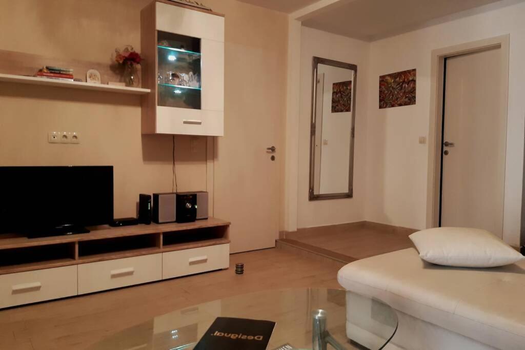 a living room with a couch and a tv at Apartmant Angel Wings in Omiš
