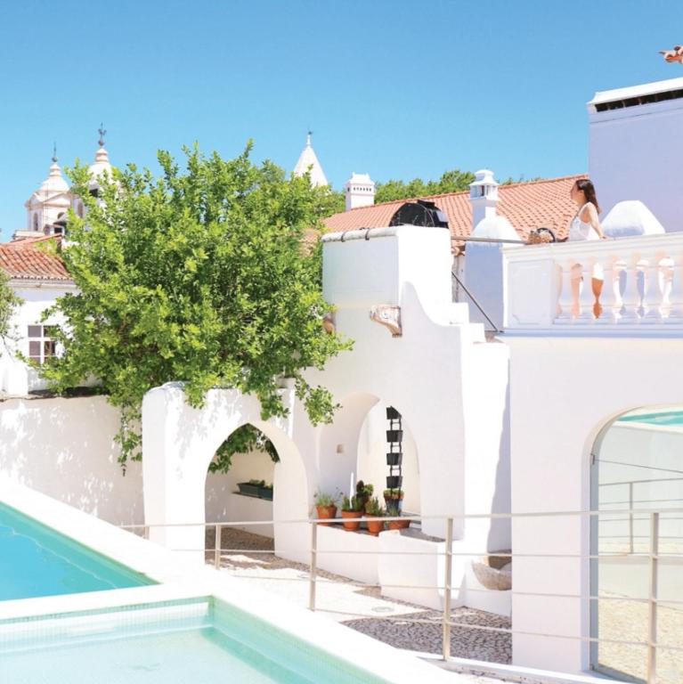 a villa with a swimming pool and a house at Hotel Solar Dos Mascarenhas in Vila Viçosa