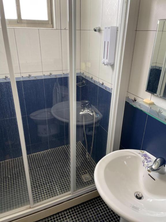a bathroom with a shower and a sink at Hai Gang Yuan Homestay in Kenting
