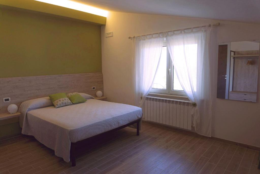 Postel nebo postele na pokoji v ubytování B&B Tra Gli Ulivi
