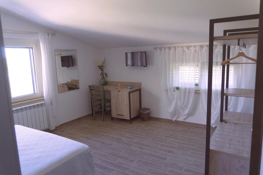 Postel nebo postele na pokoji v ubytování B&B Tra Gli Ulivi
