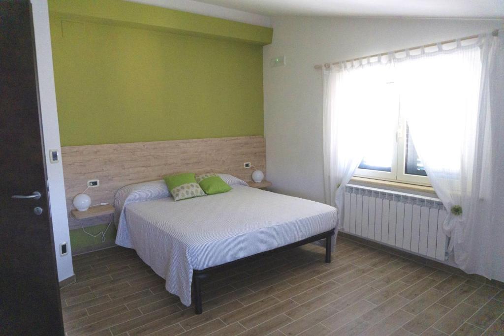 Postel nebo postele na pokoji v ubytování B&B Tra Gli Ulivi