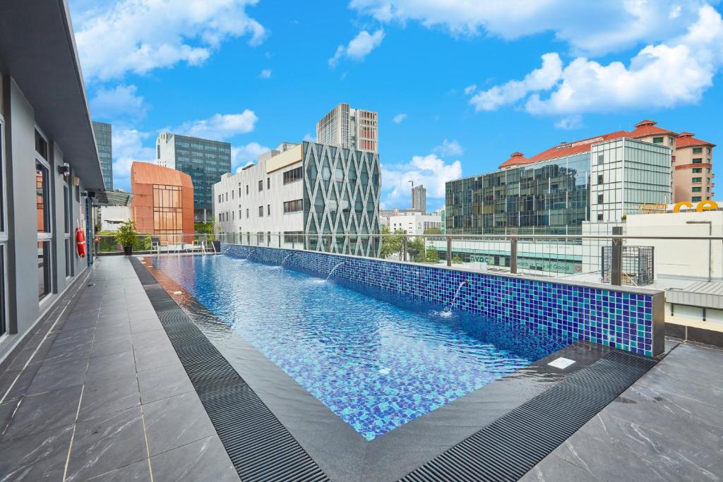 a swimming pool on the roof of a building at ibis budget Singapore Clarke Quay in Singapore