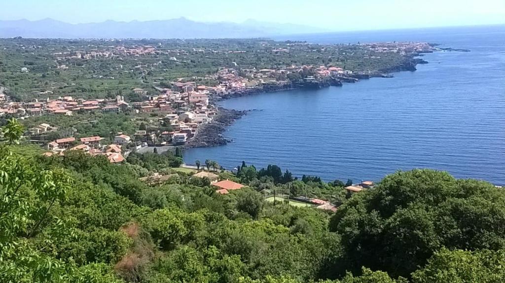 an aerial view of a city and a body of water at Tenuta la Timpa Vela rooms And pool in Acireale