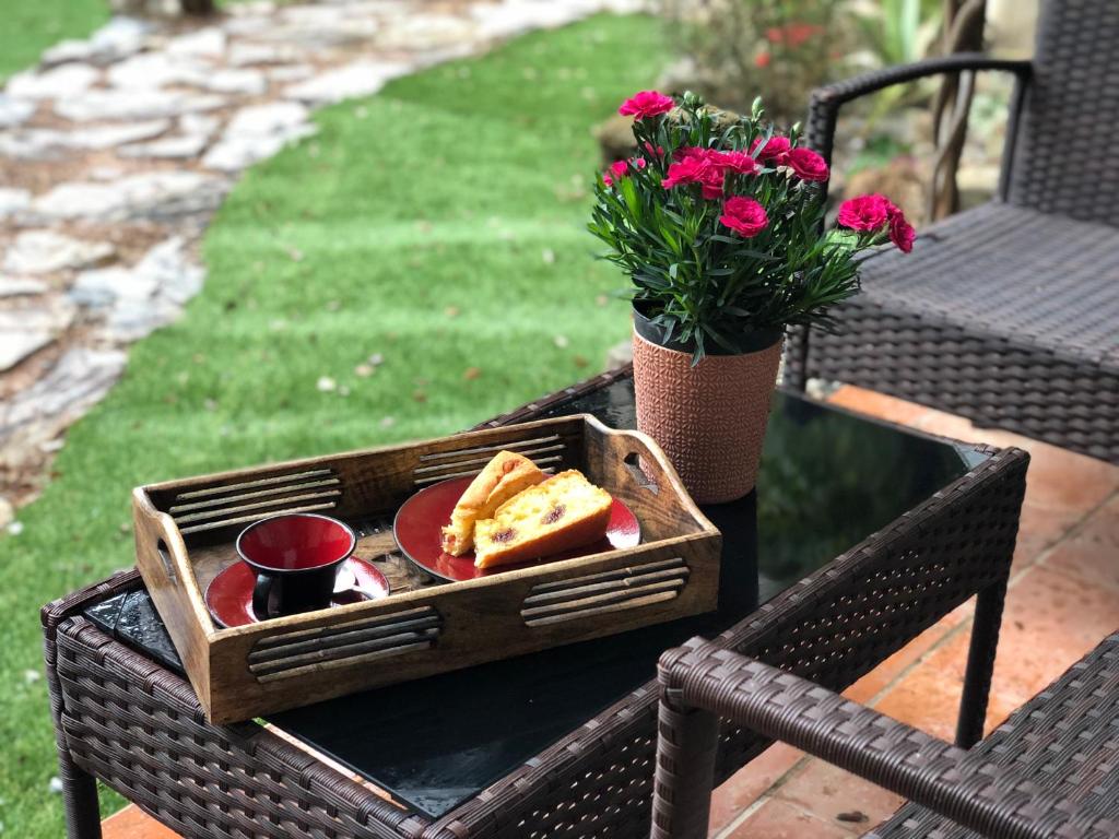 a wooden tray with bread and butter on a table at B&b Selu in Jerzu