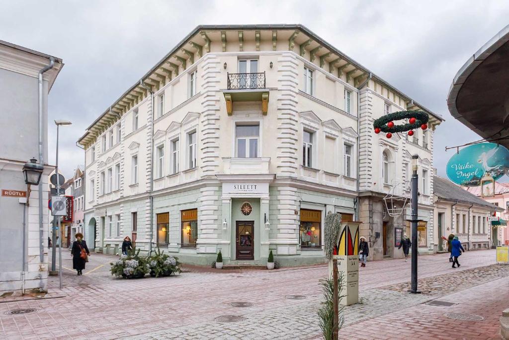 a large white building on a city street at Old Town Apartment in Pärnu